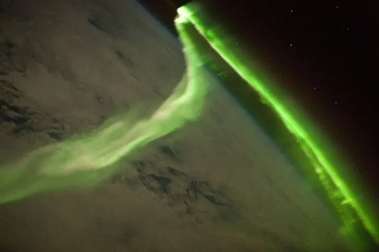 The aurora glows in the thermosphere, roughly 100 to 300 km above the ground